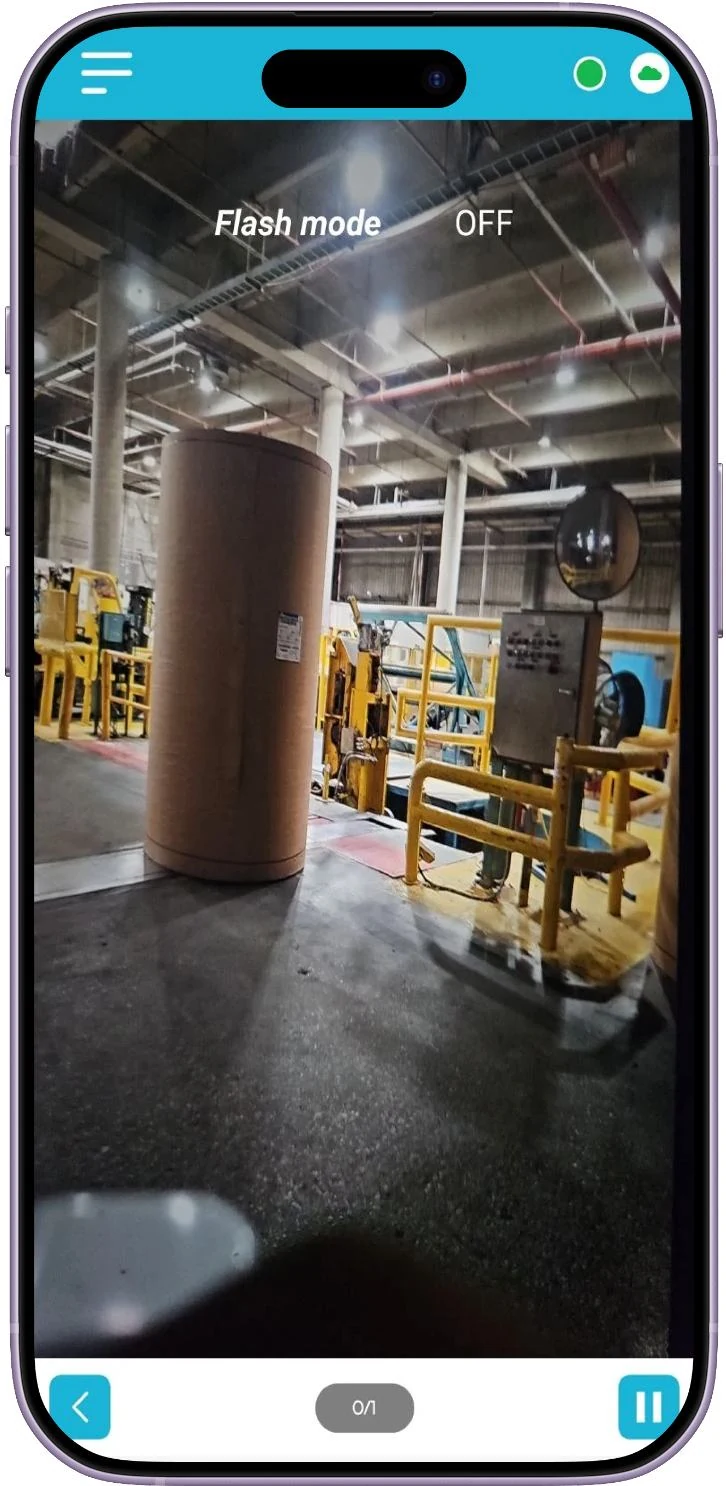 App camera screen photographing a roll of material on the production floor