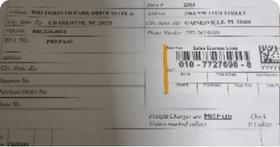 A shipping document with vendor and customer address information, a barcode, and a prepaid freight designation.
